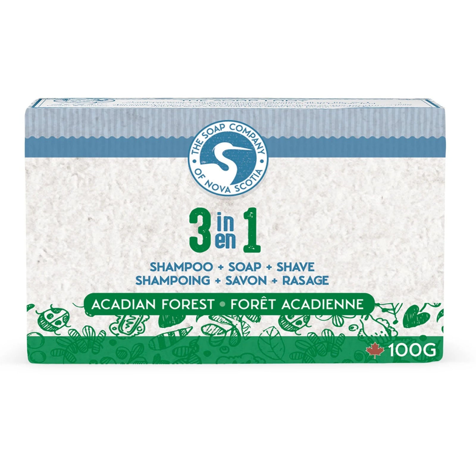 Two blocks of natural soap on a rustic wooden surface with greenery and pine cones.