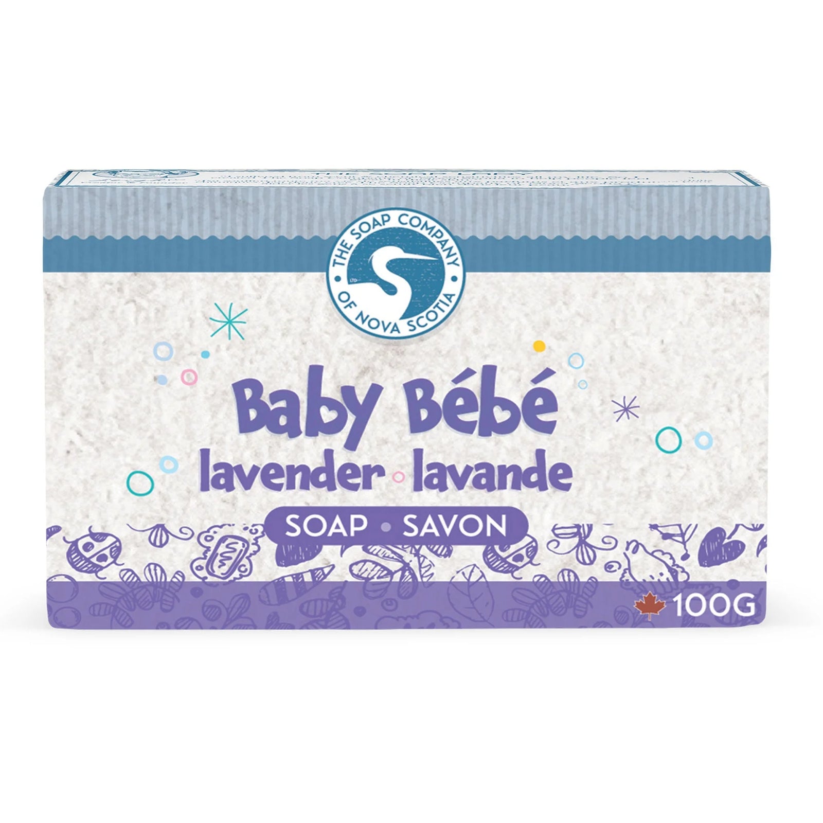 Two bars of soap with lavender and oatmeal on a white surface with a soft toy and bath items in the background.