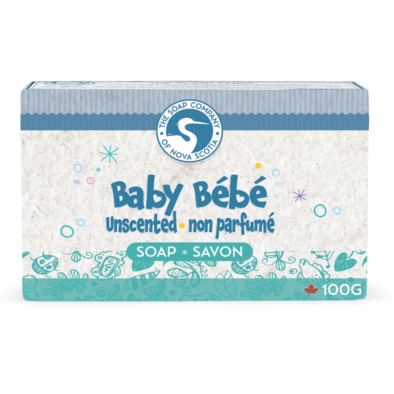 Two bars of soap with visible ingredients on a towel, surrounded by oats, a small brush, and a rubber duck.